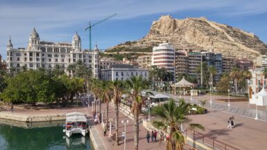 a view of the santa barbara castle against the Alicante marina