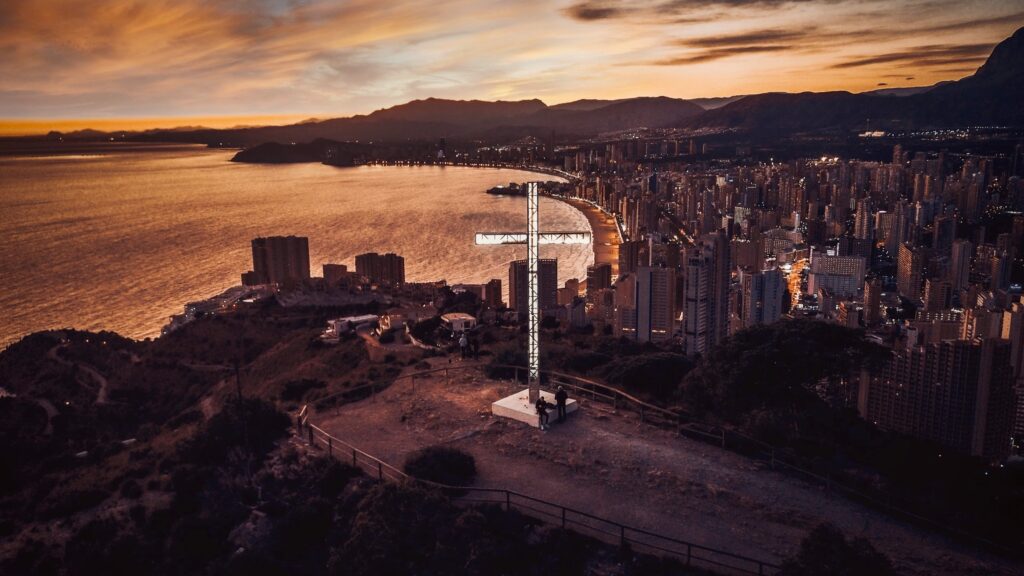 benidorm cross at sunset, overlooking benidorm city